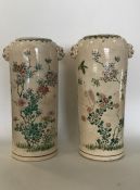 A pair of Oriental pottery cylindrical vases with