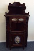 An Edwardian mahogany corner unit, the front attra