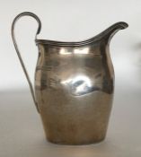 A Georgian style cream jug with reeded decoration.