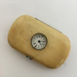 A novelty travelling watch in the form of a purse