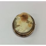 An oval shell cameo of a warrior in gold frame. Ap
