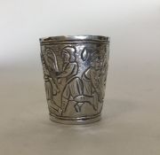 A small silver embossed spirit tot decorated with