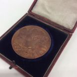 A cased brass double sided Coronation medallion. E