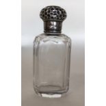 A small silver mounted scent bottle with embossed