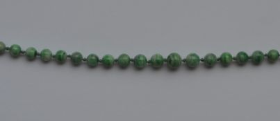 A long graduated string of tapering jade beads and