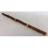 An old wooden flute with ivory inserts. Retailed b