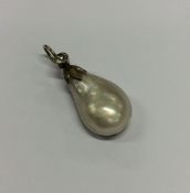 A small silver and pearl pendant with loop top. Ap