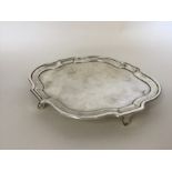 A Georgian oval silver teapot stand with wavy edge