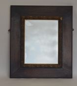 An attractive oak framed mirror decorated with gil