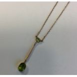 An attractive peridot drop pendant on fine link ch