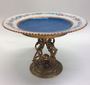 An attractive enamel plate on gilded stand and scr