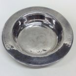 A E JONES: A circular silver shallow dish with ham