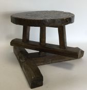 An unusual rustic swivel stool on spreading suppor