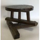 An unusual rustic swivel stool on spreading suppor