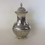 A good quality half fluted silver sugar caster wit