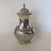 A good quality half fluted silver sugar caster wit