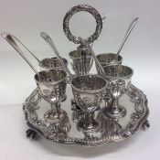 A good silver plated egg cruet on stand decorated