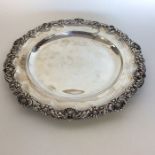 A Georgian silver circular waiter with shell and s