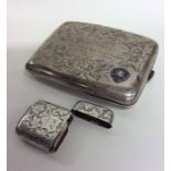 A heavy silver enamel decorated cigarette box toge