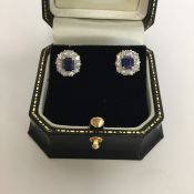 An attractive pair of sapphire and diamond cluster