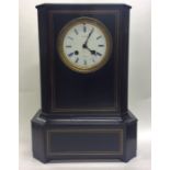 A large French ebony mantle clock with white ename