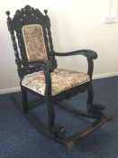 A massive Colonial carved rocking chair with scrol