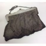 A heavy silver attractively engraved mesh purse wi