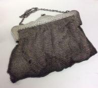 A heavy silver attractively engraved mesh purse wi