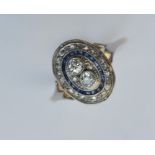 A sapphire and diamond oval cluster ring in two-co