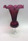 A cranberry glass vase with wavy mount. Approx. 26