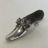 A novelty silver pin cushion in the form of a shoe