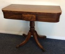 An early Victorian tea table with scroll pedestal.