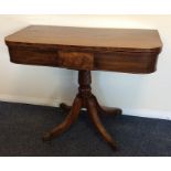 An early Victorian tea table with scroll pedestal.