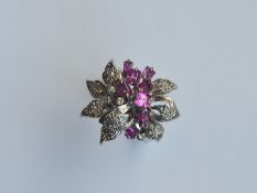 A 14 carat ruby and diamond ring in the form of a