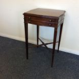 An Edwardian mahogany side table with stretcher ba