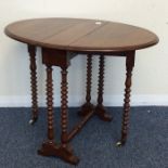A small mahogany Sutherland table with turned supp
