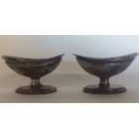 A pair of silver salts engraved with swags and gil