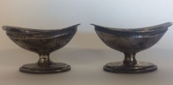 A pair of silver salts engraved with swags and gil