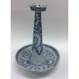 A Chinese blue tapering candlestick decorated with