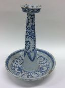 A Chinese blue tapering candlestick decorated with