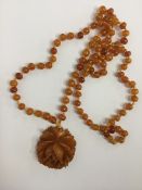 A graduated string of yellow amber beads. Approx.
