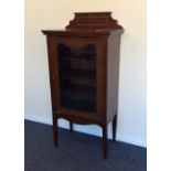 An Edwardian display cabinet on tapering supports