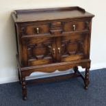 An oak Jacobean style two door side unit. Est. £50