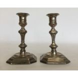 A pair of Georgian style silver candlesticks, the