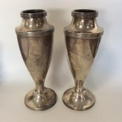 A tall pair of silver spill vases with reeded deco