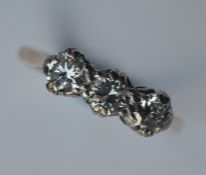 An 18 carat diamond three stone ring in claw setti