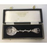 A boxed silver commemorative spoon decorated with