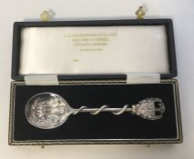 A boxed silver commemorative spoon decorated with