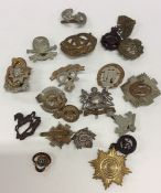 A small collection of brass and other cap badges.