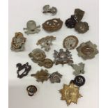 A small collection of brass and other cap badges.